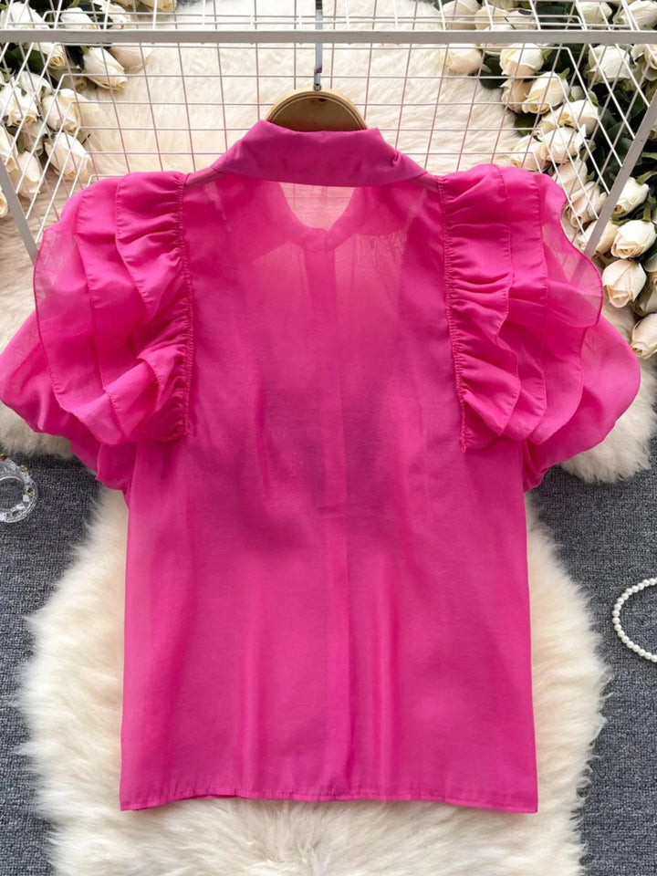 Levoire | Top avec des diamants transparents et fins et des manches bouffantes