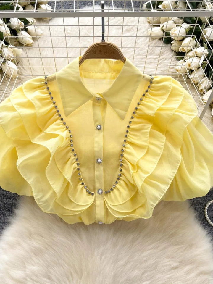 Levoire | Top avec des diamants transparents et fins et des manches bouffantes