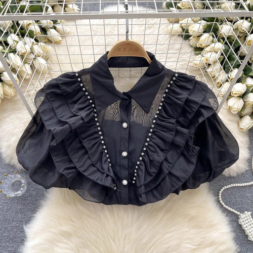 Levoire | Top avec des diamants transparents et fins et des manches bouffantes
