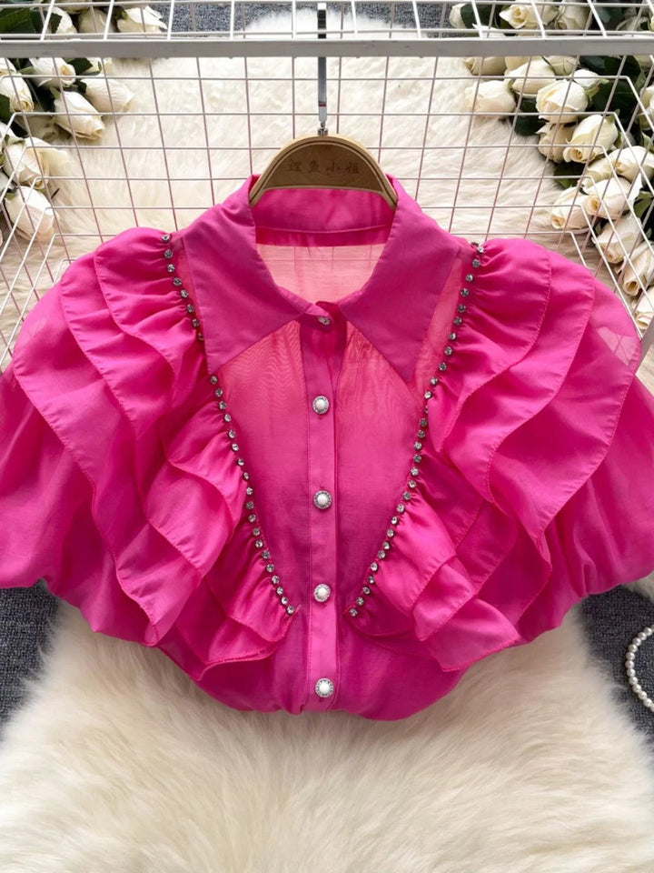 Levoire | Top avec des diamants transparents et fins et des manches bouffantes
