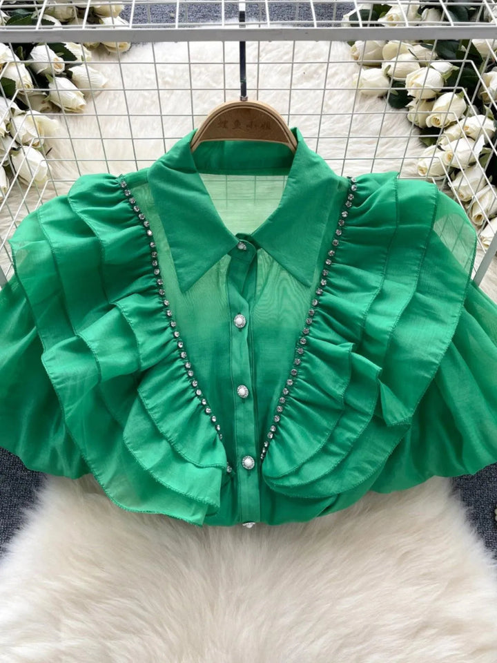 Levoire | Top avec des diamants transparents et fins et des manches bouffantes